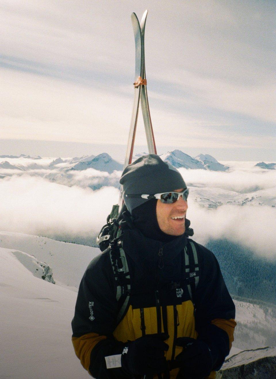 Sean Pettit carrying his skies on his back.