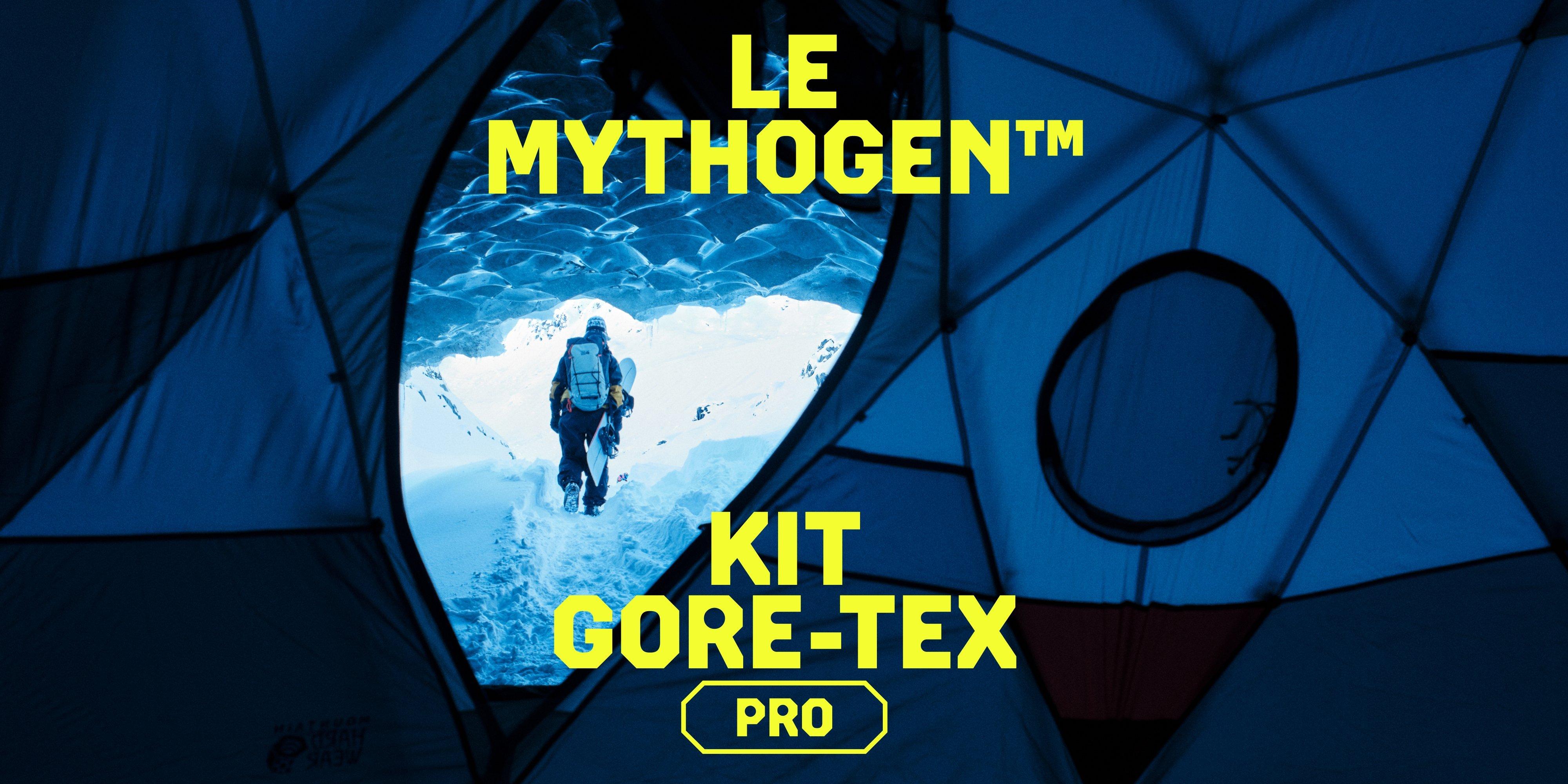 Looking through the Stronghold Dome Tent, A snowboarder walks through snow with board in tow, kitted out in the Mythogen Gore-tex Pro kit.