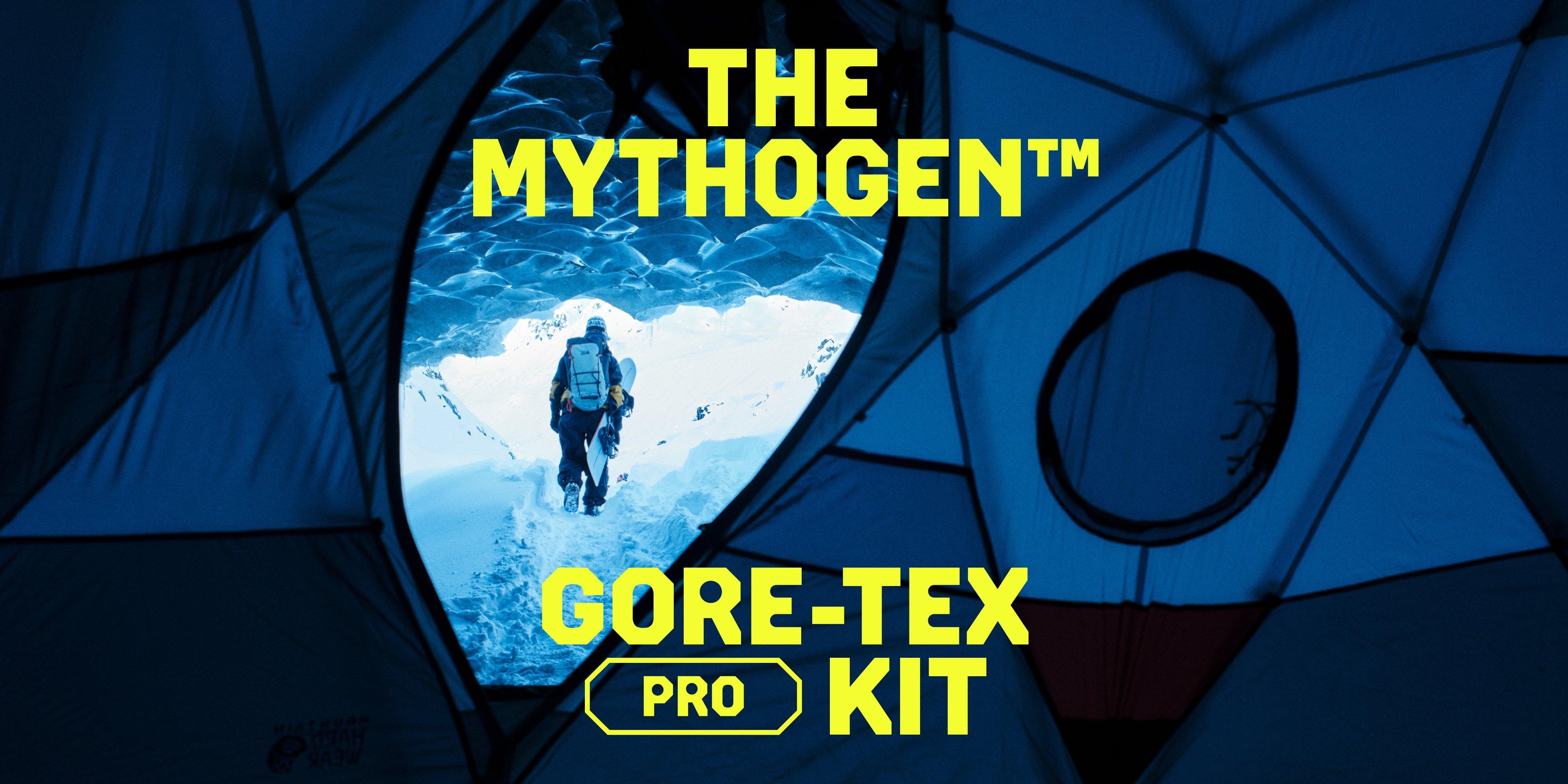 Looking through the Stronghold Dome Tent, A snowboarder walks through snow with board in tow, kitted out in the Mythogen Gore-tex Pro kit.
