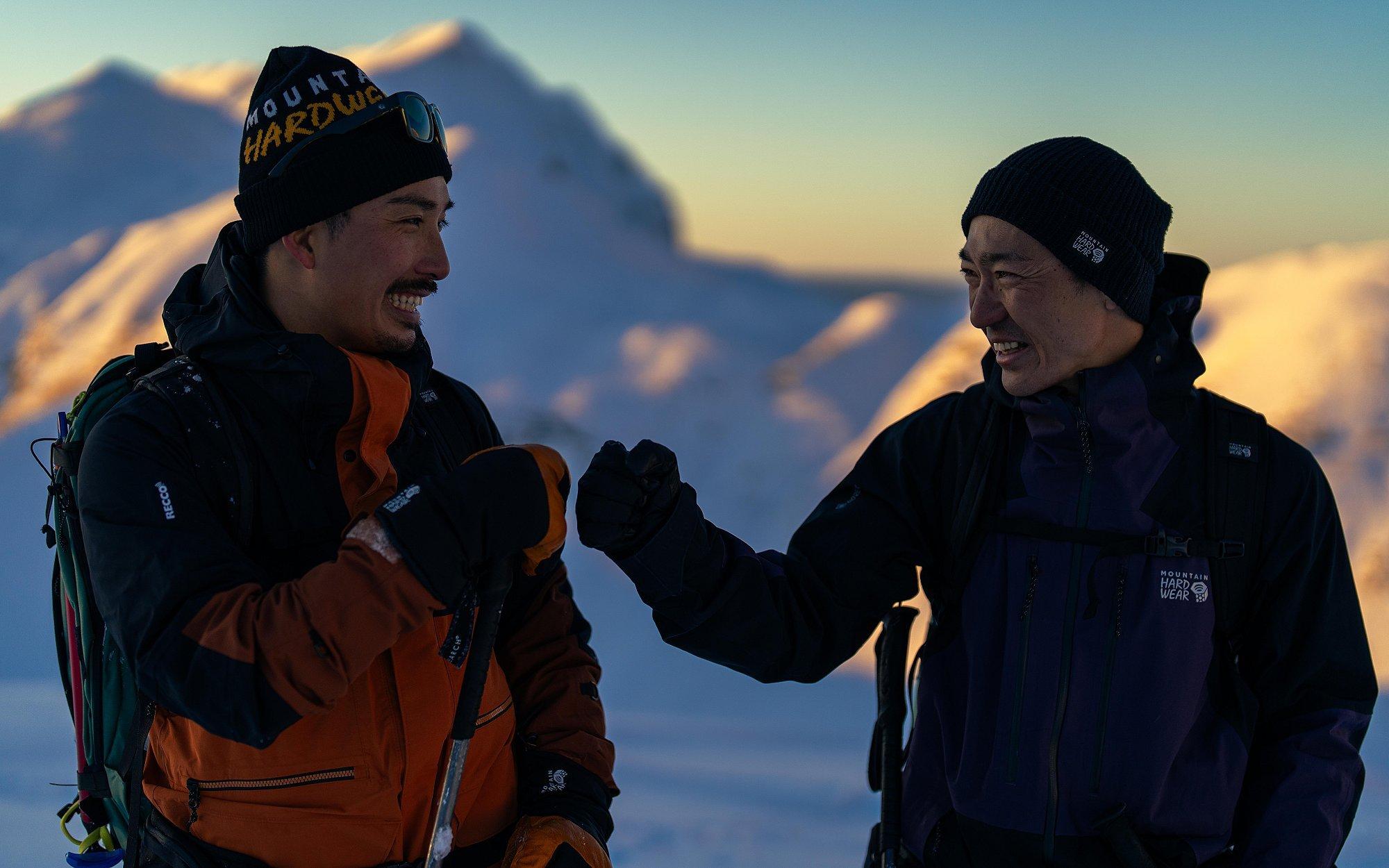 Daisuke and Keisuke fist bump and are all smiles.
