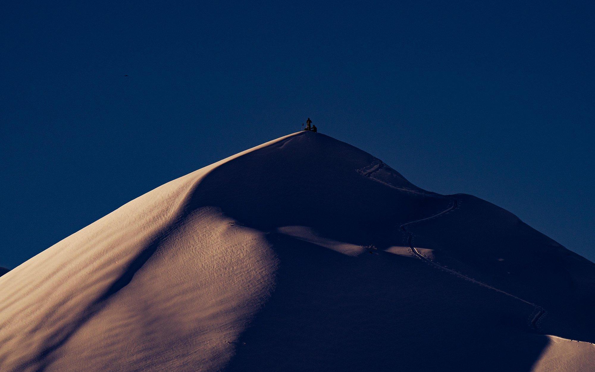 Big mountain, tiny Daisuke and Keisuke at the top with very dramatic shadows on the ridge.