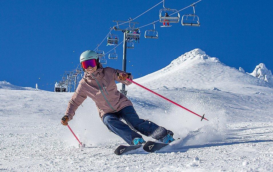 Mt. Bachelor team athlete Ashley McNeish skis down a mountain on a sunny day. 