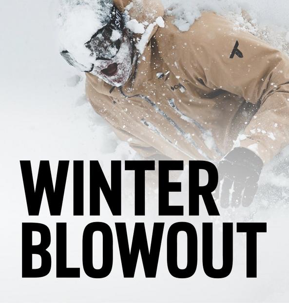 A stylish woman in hiking gear in a rugged environment.