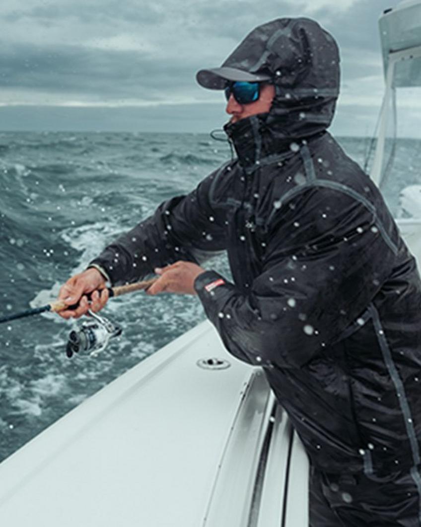 Man fishing off the side of a boat.