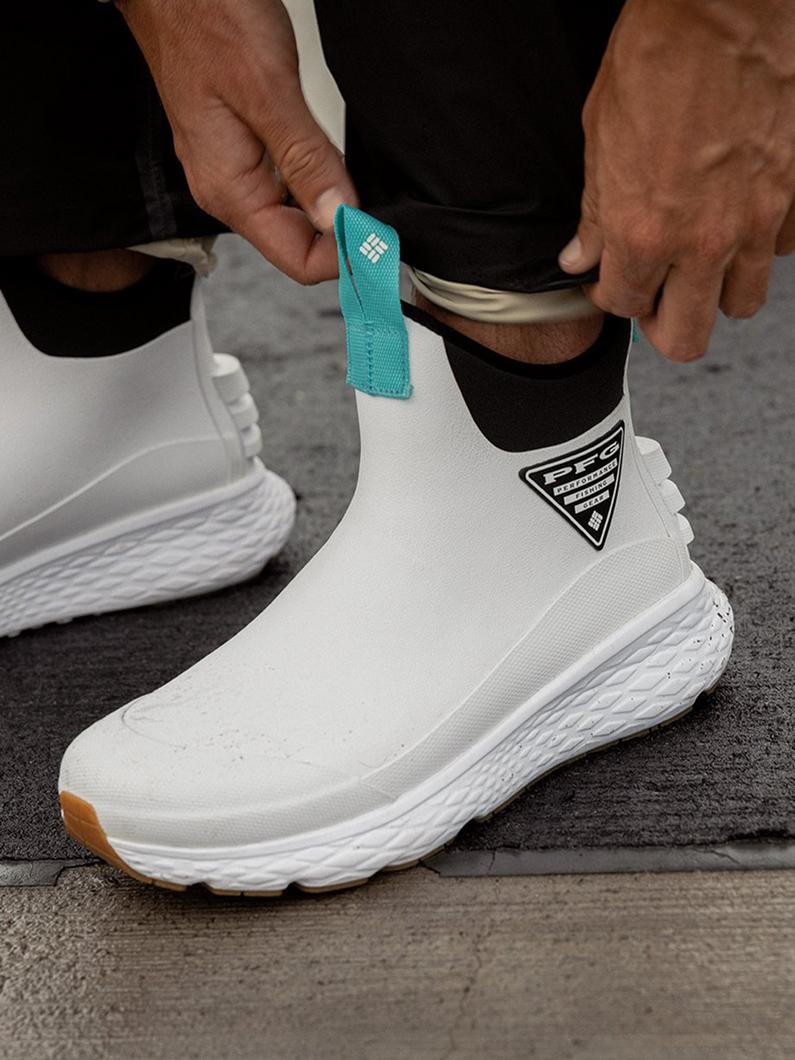 Close-up of an angler's white deck boot.