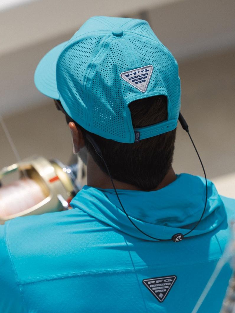 Close up of a man wearing a PFG hat while fishing. 