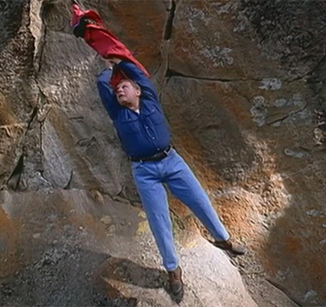 Tim Boyle dangling off a cliff hanging on to a Columbia jacket.