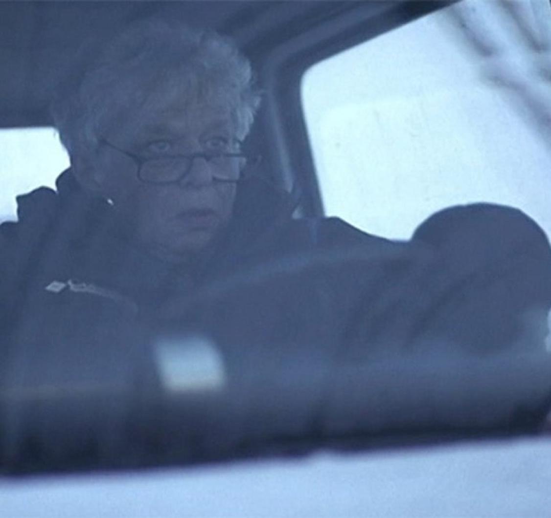 Gert Boyle driving a snow plow with a look of determination.