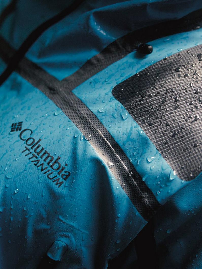 Close up of someone in a blue rain jacket.