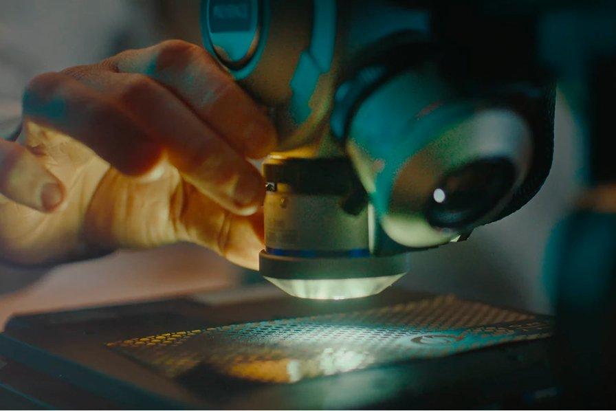 Someone looking into a microscope.