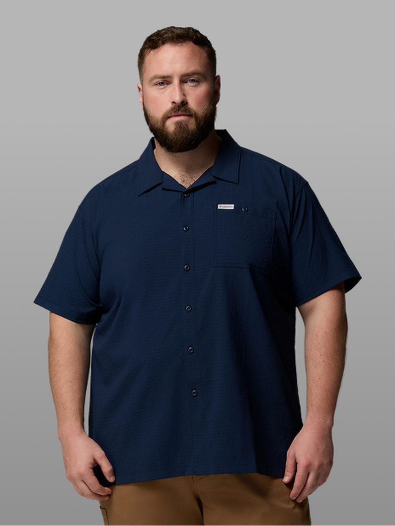 A man wearing a short-sleeve button-up.