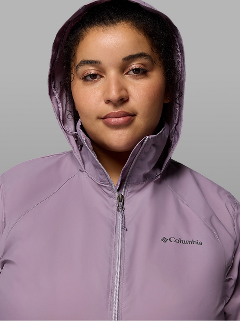 A woman wearing a purple jacket.