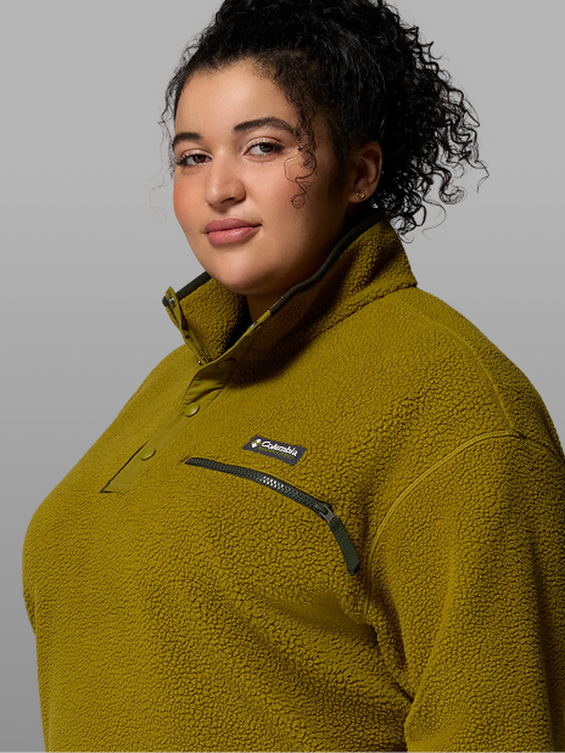 A woman wearing a green fleece pullover.