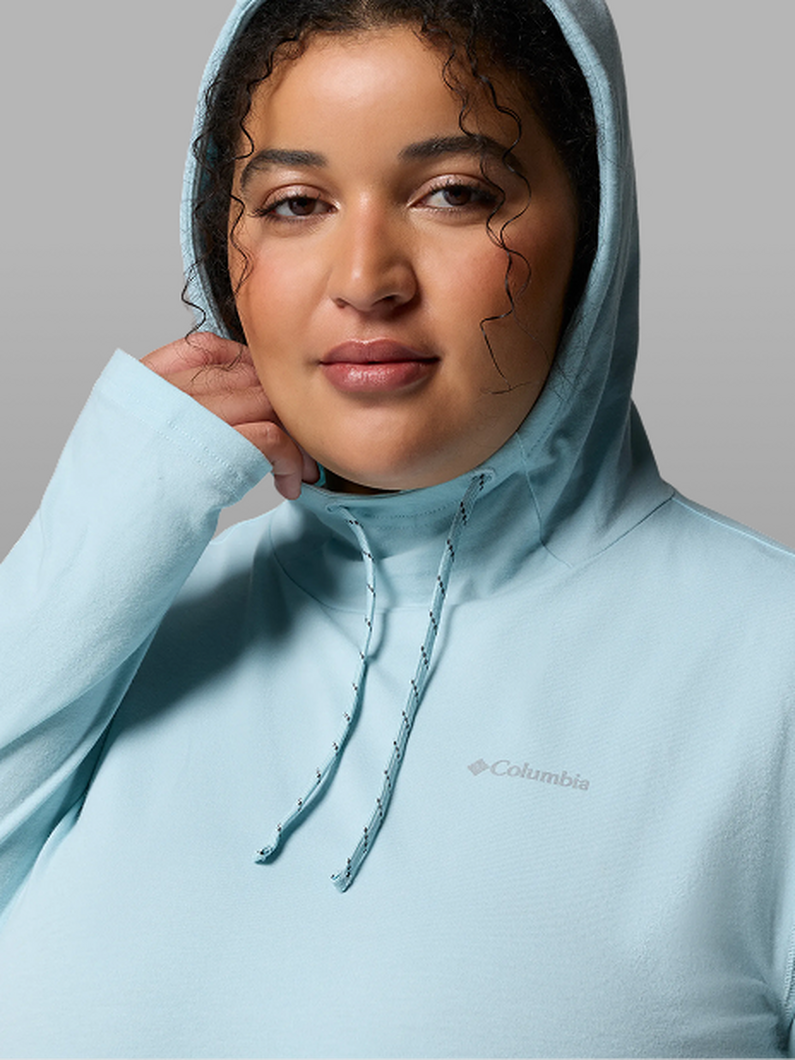 A woman wearing a blue hoodie with the hood up.