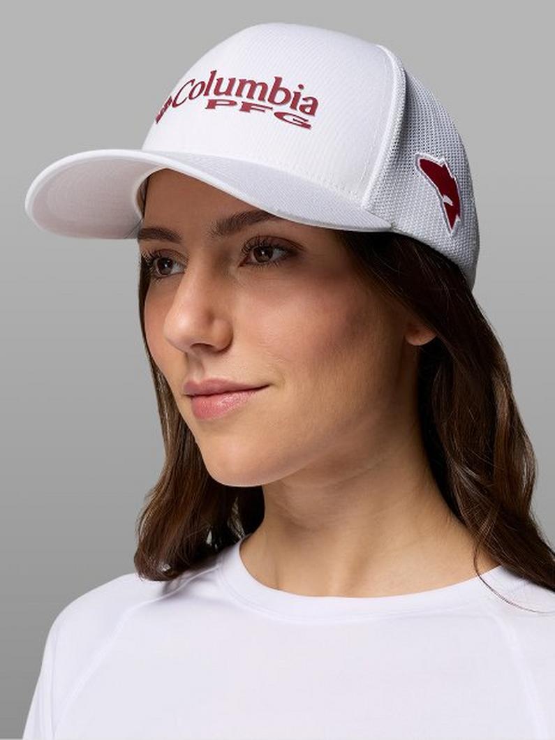 Woman wearing a white trucker hat with red text and mesh back panels.