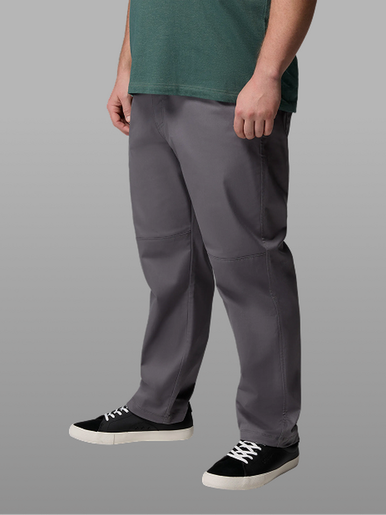 Waist-down image of a man wearing grey pants and sneakers.