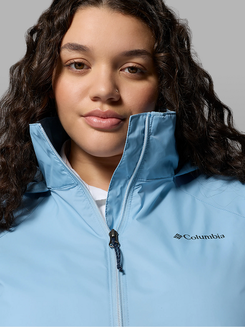 A woman wearing a blue rain jacket.