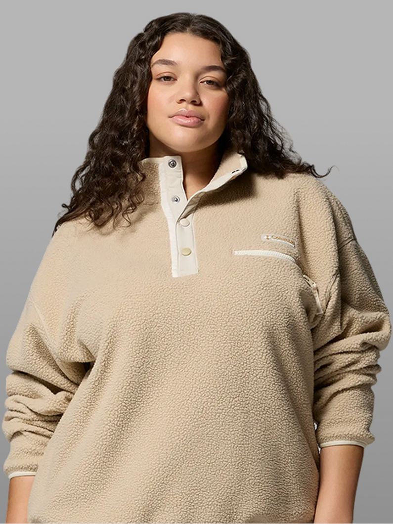A woman wearing a beige fleece pullover.