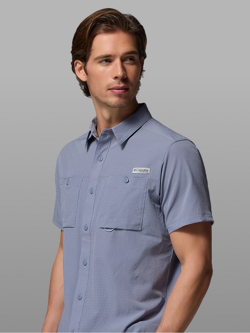 A man wearing a blue short-sleeve button-up.