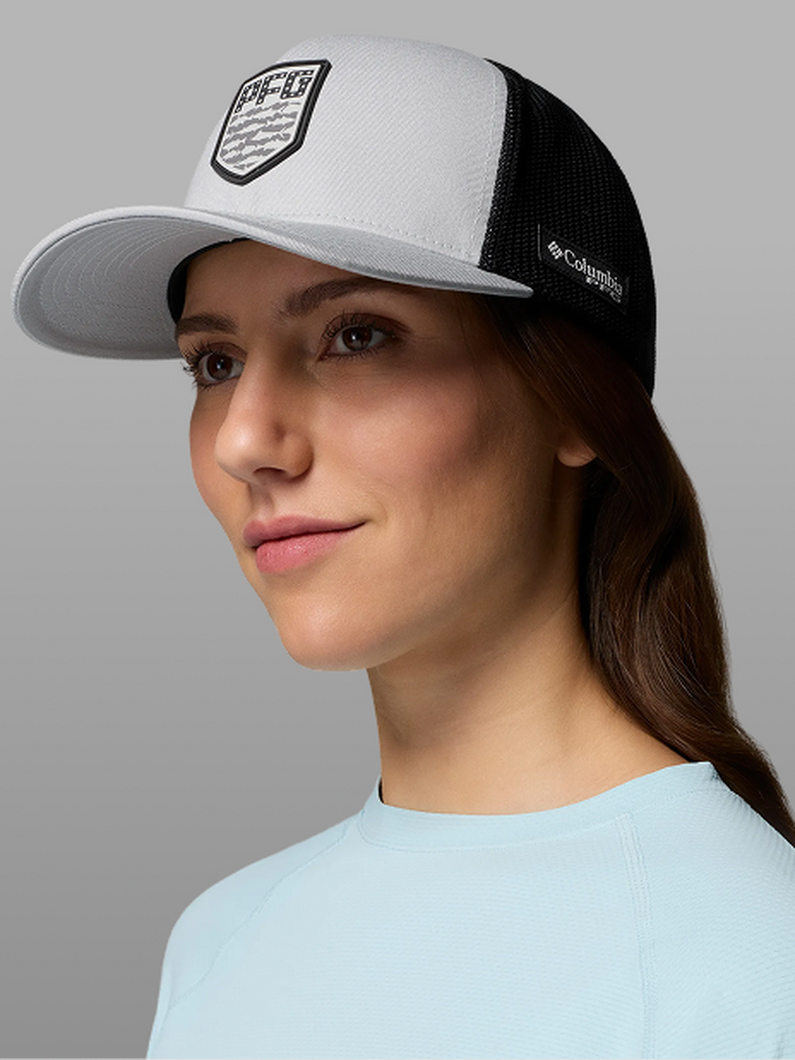 A woman wearing a white and black PFG hat.