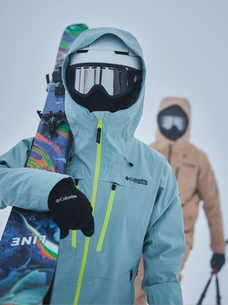Two skiers covered in gear.