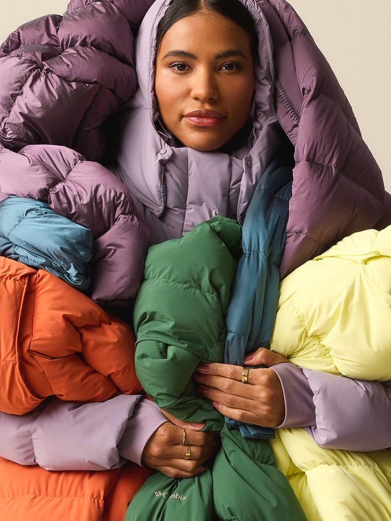 A woman wrapped up in a bunch of the Amaze Puff jackets.