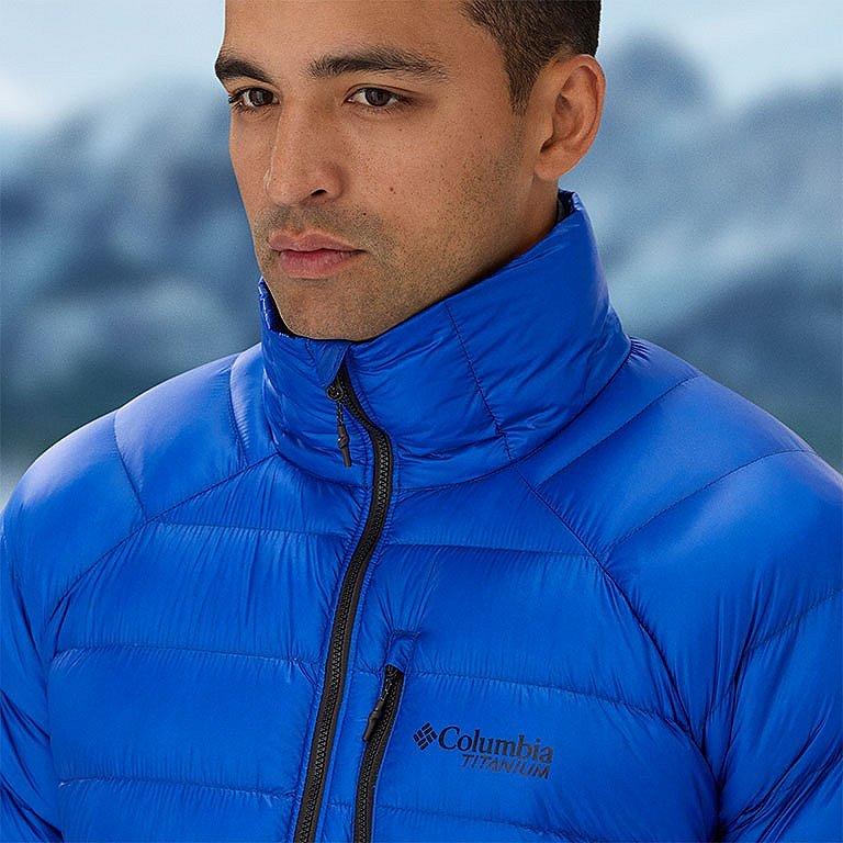 Model trekking down a slope with one knee belt, showing how the pants have a little more room in the articulated knee for easier movement.