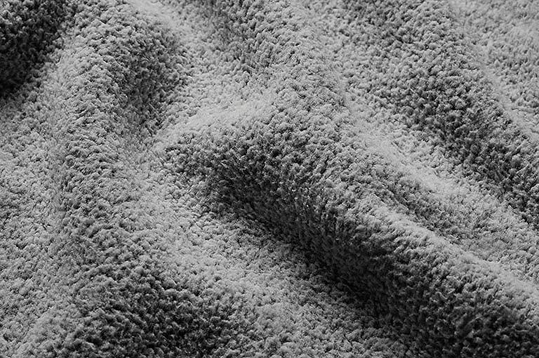 Close up of the pant's tan fabric with the Omni Wick logo in the bottom left and a graphic showing how moisture rises to the fabric's surface to evaporate in the bottom right.