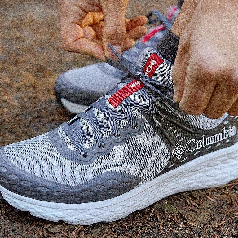 Close up shot of a person tieing the Konos laces