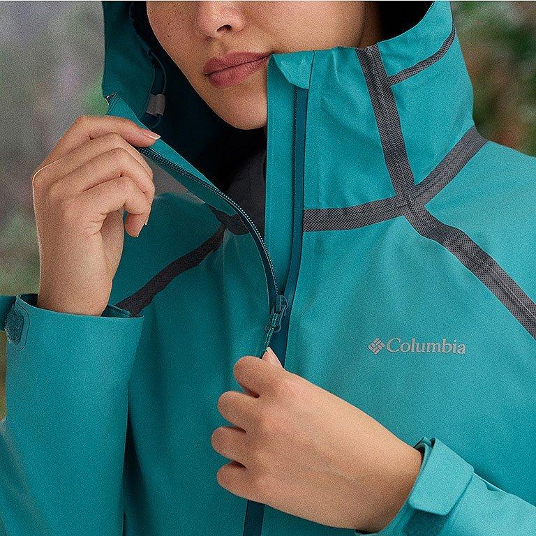 Close-up of a woman buttoning a Silver Ridge shirt. 