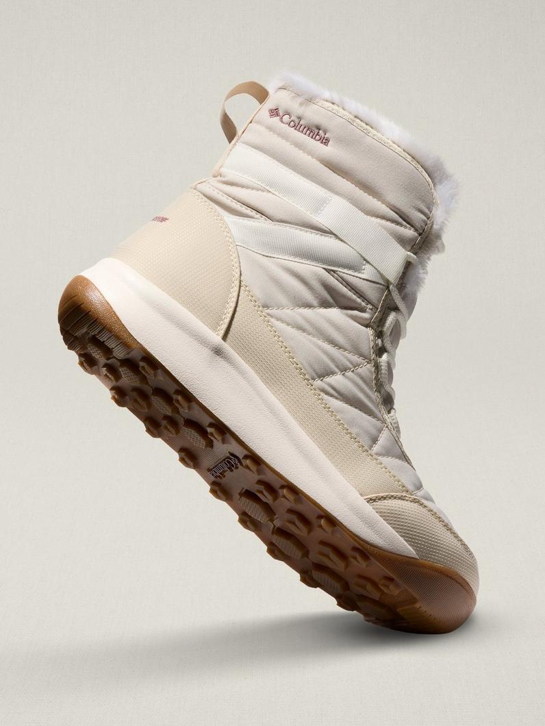 A three-quarter side view of a white boot.