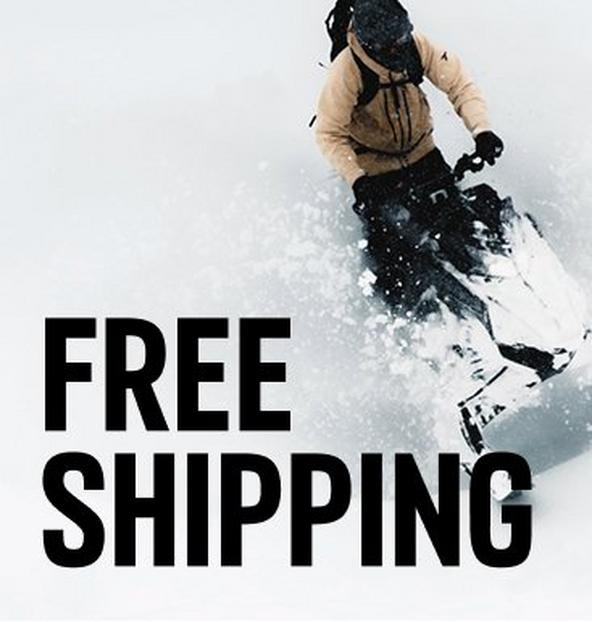 A snowmobiler speeding through fresh powdery snow.