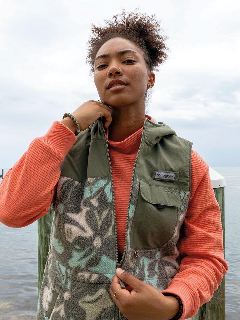 A woman wearing a coral jacket.