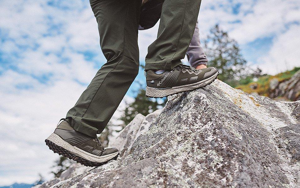 Scaling a steep boulder is no challenge for this person, thanks to Columbia's shoes with soles inspired by goat's hooves.