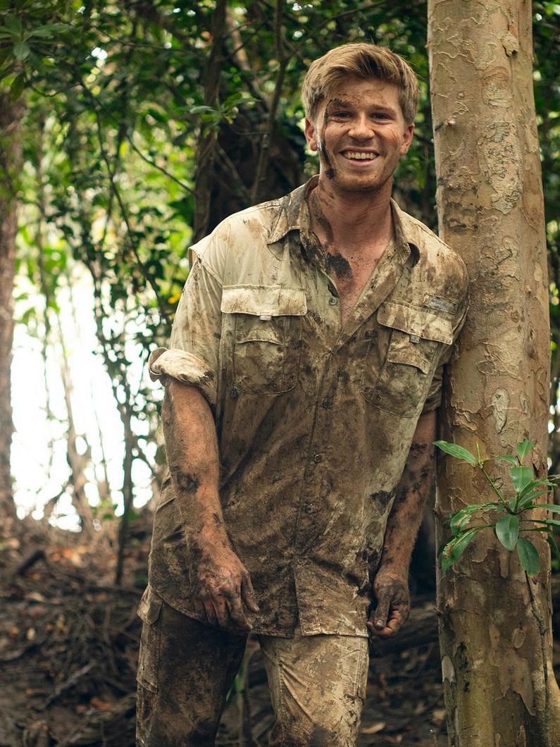 Columbia ambassador Robert Irwin in a muddy rainforest.