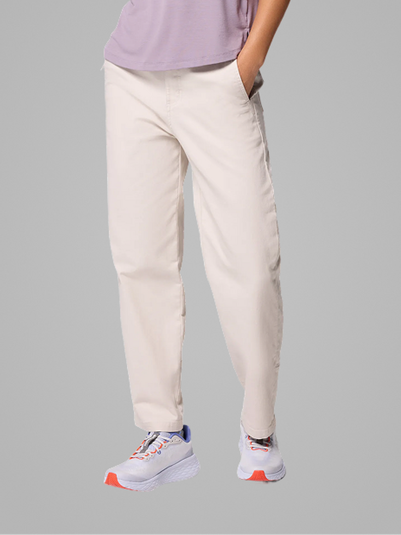 Waist-down image of a woman wearing brown pants and sneakers with text: Bottoms