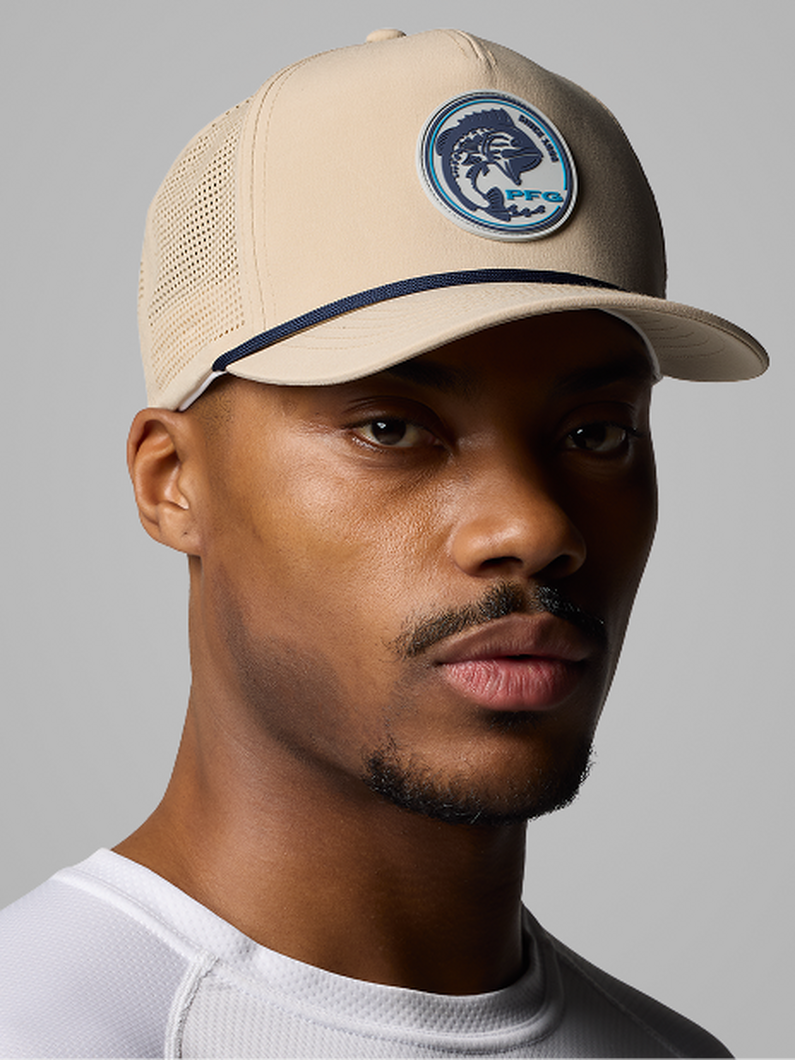 Side profile of a man wearing a gold beanie with text: Accessories