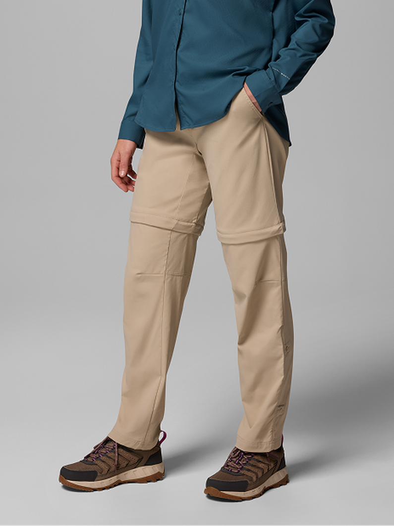 Waist-down image of a woman wearing brown pants and sneakers with text: Bottoms