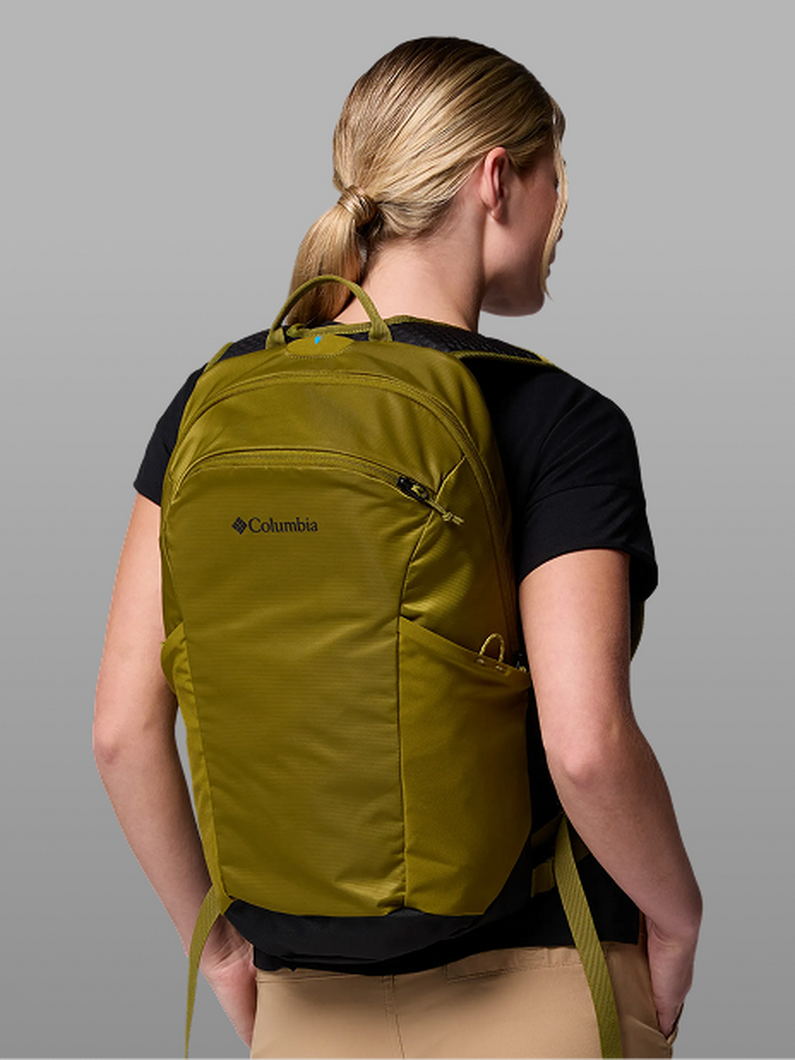 A woman facing away, wearing a grey and purple backpack.