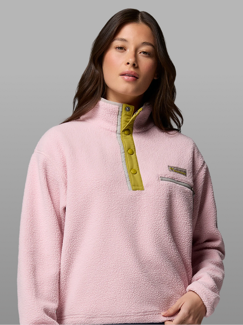A woman wearing a pink fleece pullover.