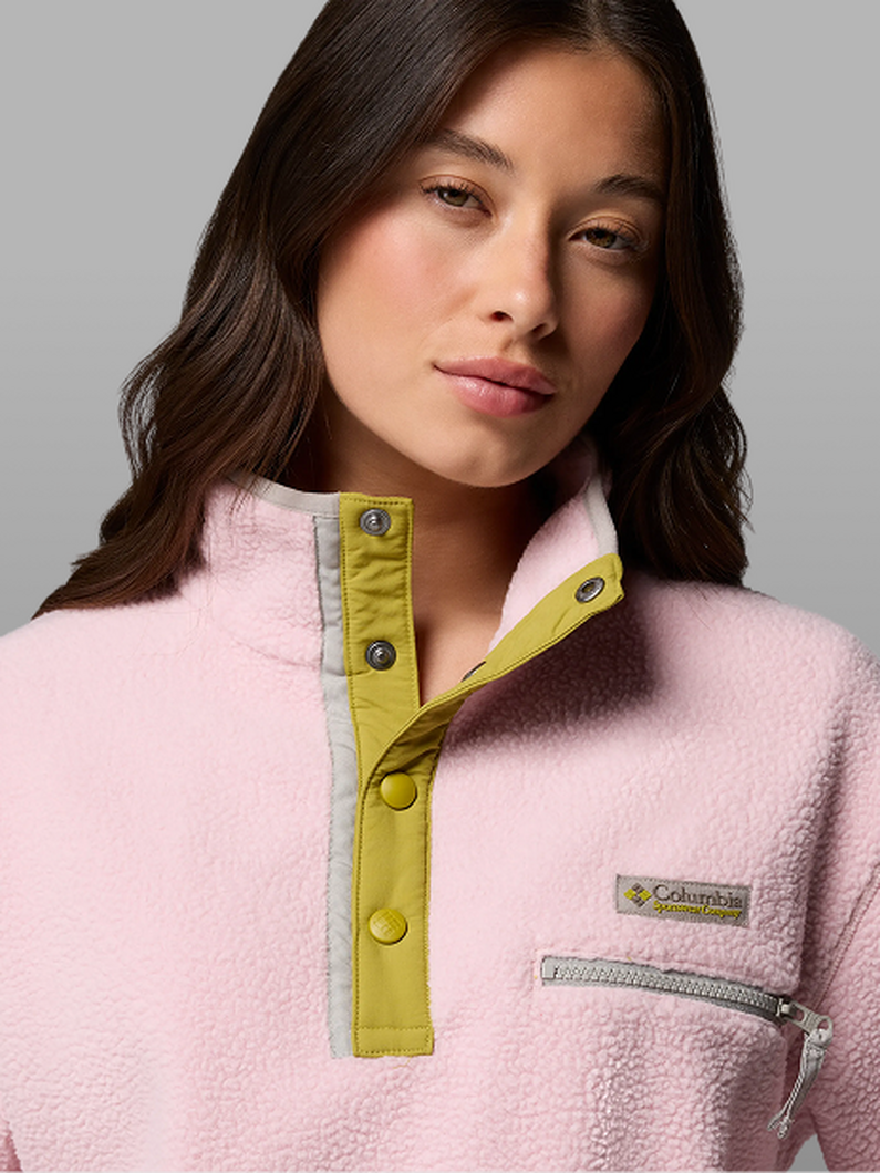 A woman wearing a pink fleece pullover.