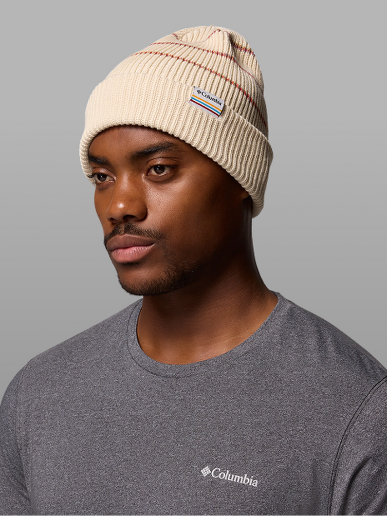 A man wearing a tan beanie.
