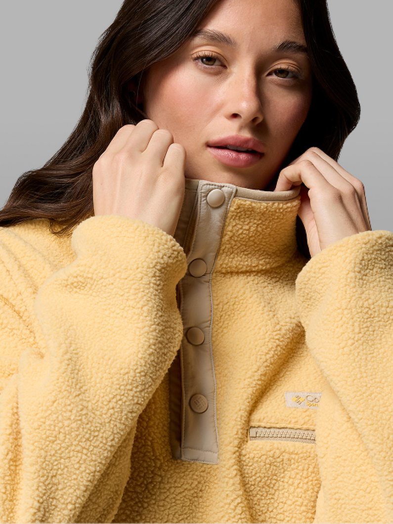 A woman wearing a yellow fleece pullover.