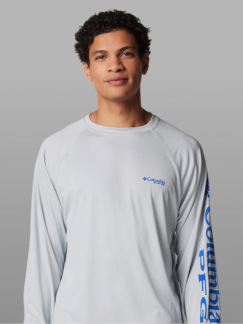 A man wearing a white long-sleeve shirt with the Columbia PFG logo on the sleeve.