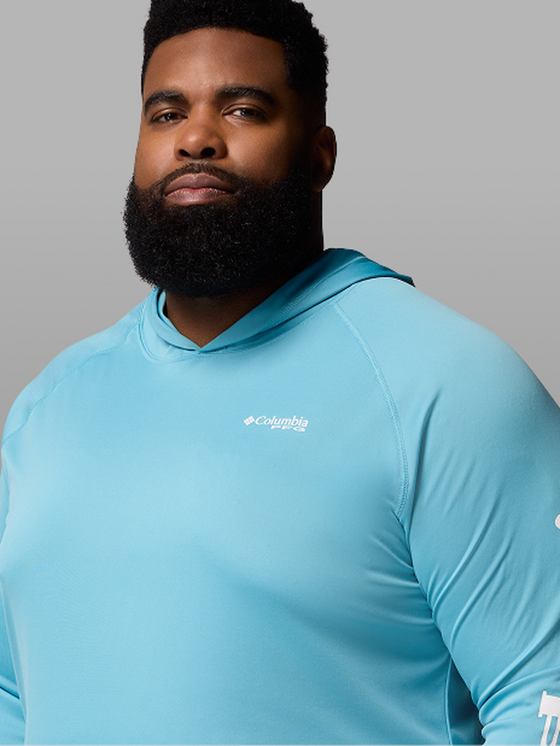 A man wearing a light blue pullover.