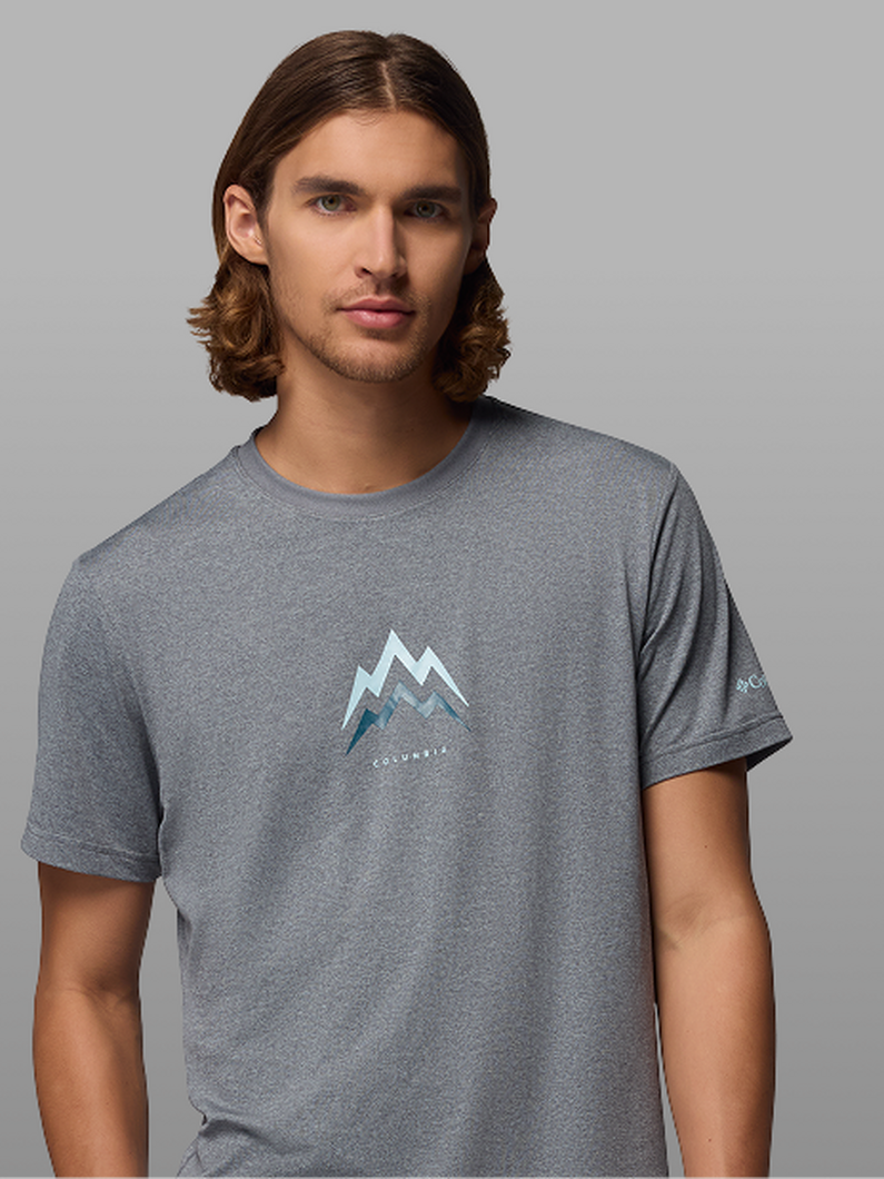 A man wearing a grey graphic t-shirt.