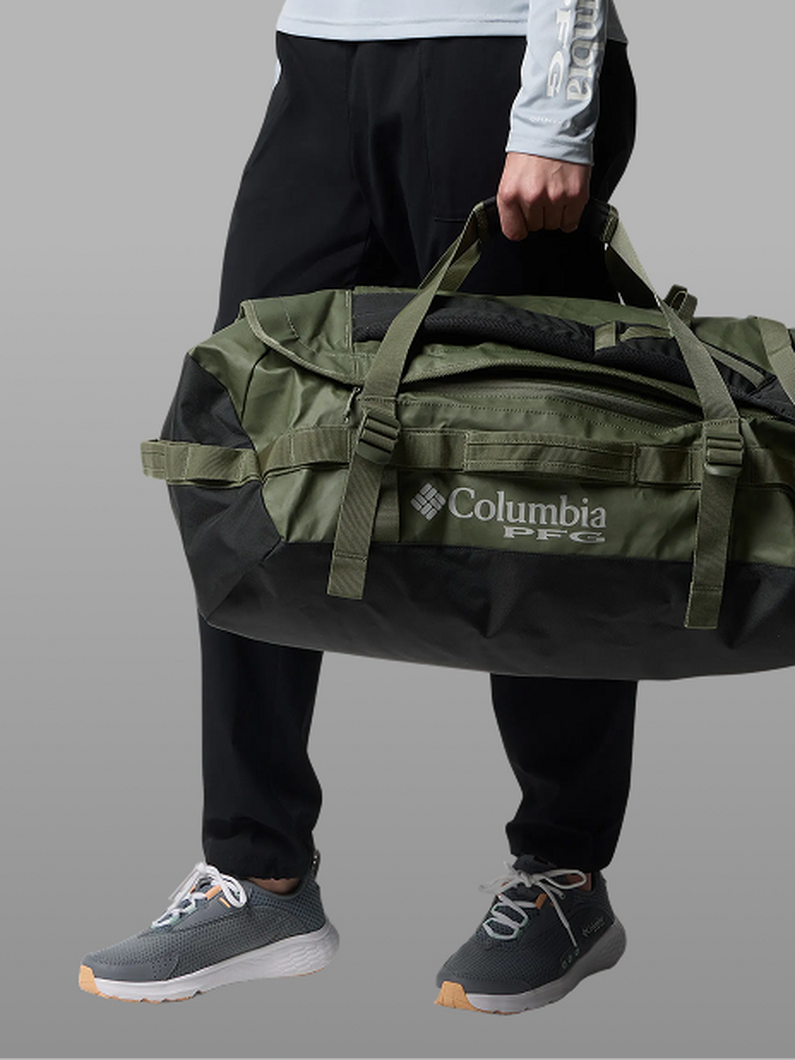 A woman wearing a red duffel bag.