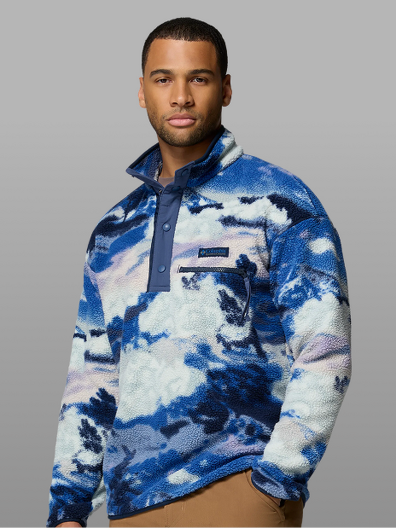 A man wearing a blue patterned fleece pullover.