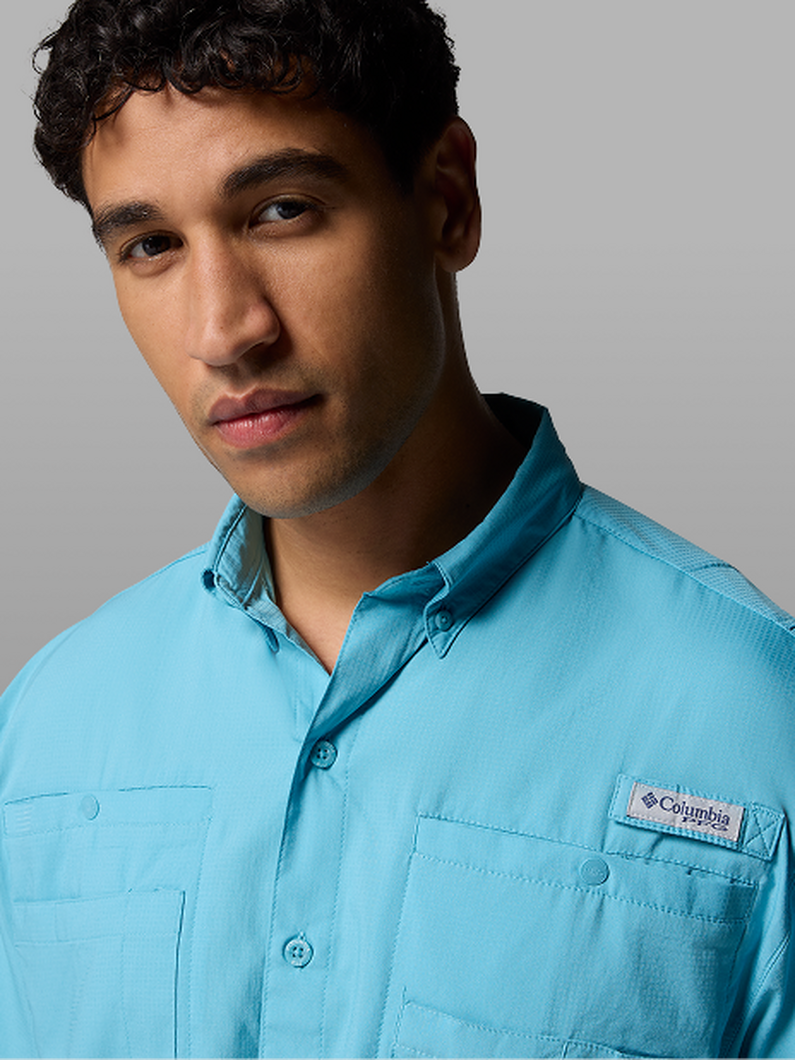 A man wearing a blue button-up shirt.