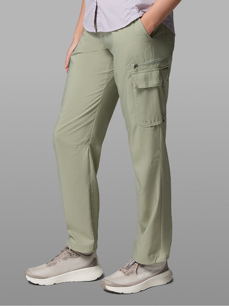 Waist-down image of a woman wearing green pants and sneakers.